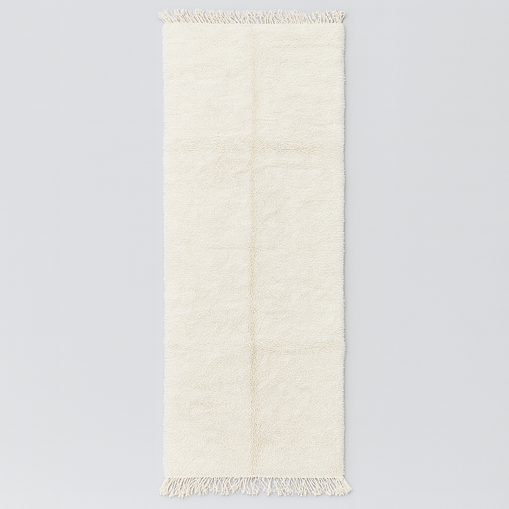 Handmade Moroccan runner rug in solid white natural wool with minimalist tassels, crafted by Berber artisans.
