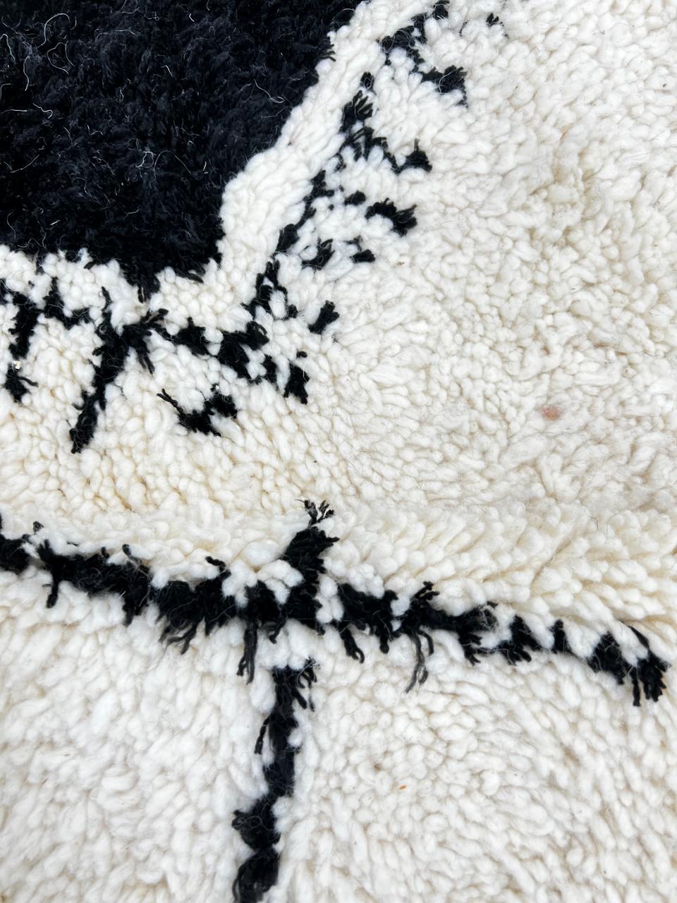 Handmade white Moroccan runner rug with black tribal Berber symbols and diamond patterns.