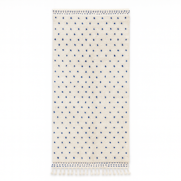 Handmade white Moroccan runner rug with small blue dotted pattern, woven from natural wool by Berber artisans.
