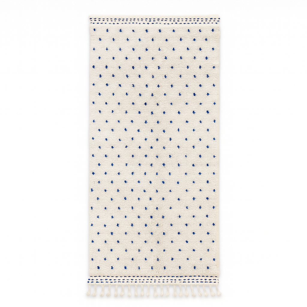 Handmade white Moroccan runner rug with small blue dotted pattern, woven from natural wool by Berber artisans.