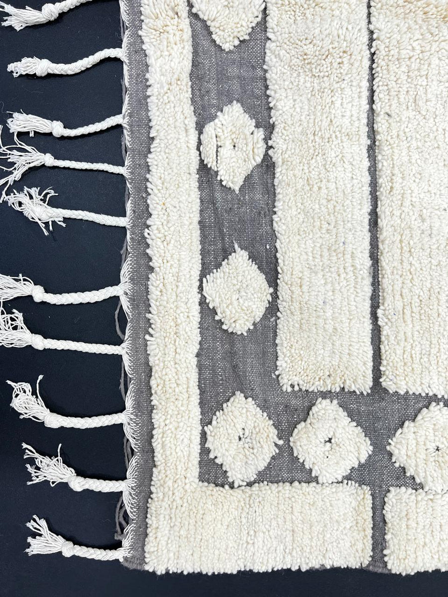 Handmade white Moroccan runner rug with grey tribal border and diamond motifs, Berber wool hallway carpet, minimalist modern Moroccan runner design.