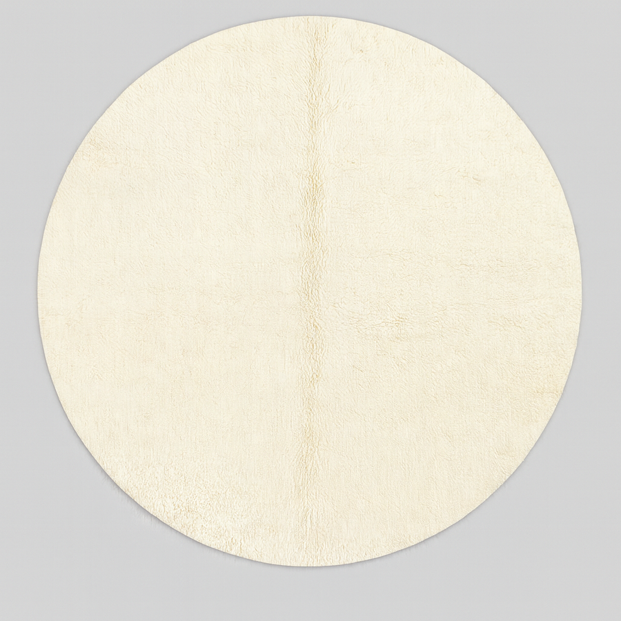 Round white Moroccan wool rug with soft plush texture and minimalist design.