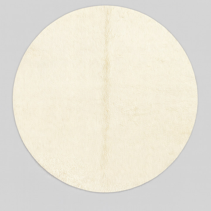 Round white Moroccan wool rug with soft plush texture and minimalist design.