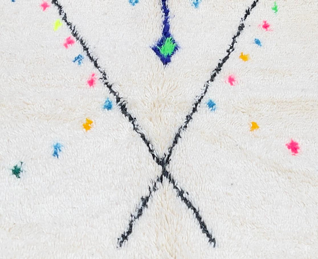 Handmade white Moroccan wool runner rug with minimalist Berber motifs, colorful diamonds, arrows, and geometric tribal symbols