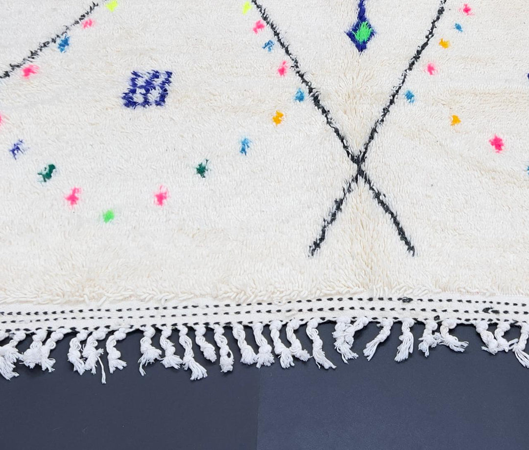 Handmade white Moroccan wool runner rug with minimalist Berber motifs, colorful diamonds, arrows, and geometric tribal symbols