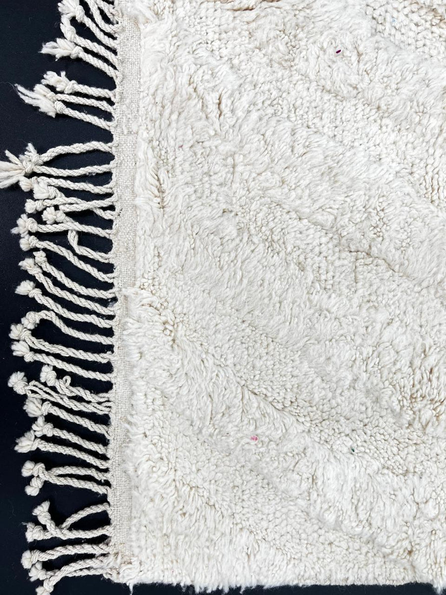 Handmade white Moroccan runner rug with subtle carved chevron texture in natural wool.