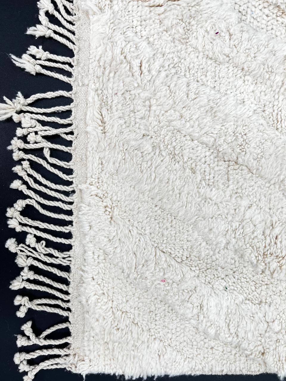 Handmade white Moroccan runner rug with subtle carved chevron texture in natural wool.