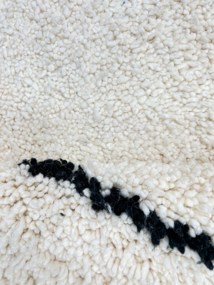 Handmade Moroccan wool runner rug in white with black diamond-line design, Beni Ourain style