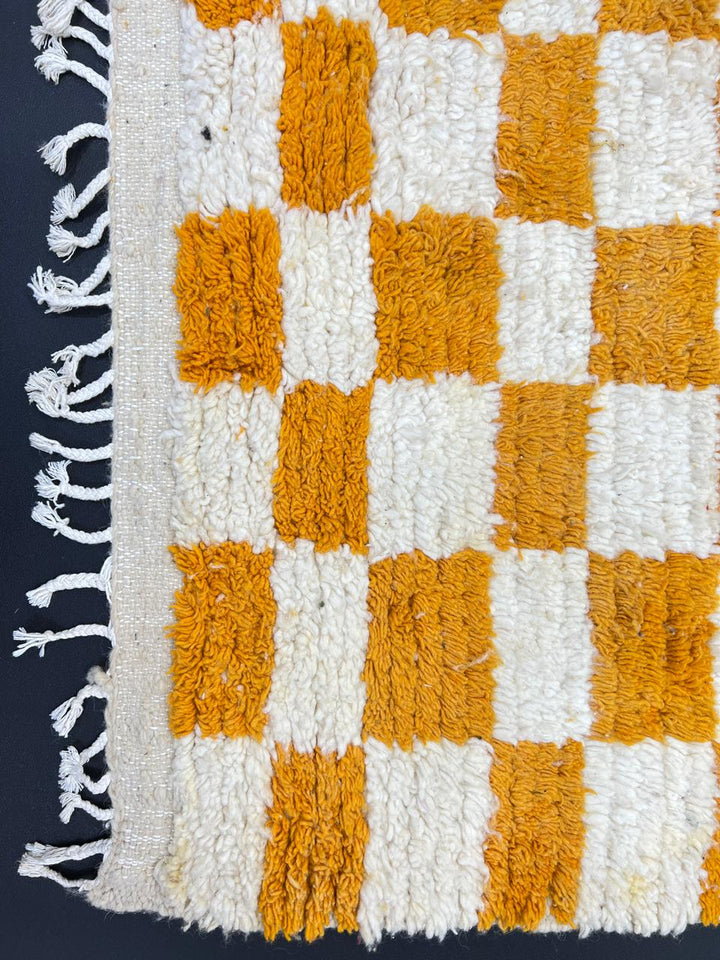 Handwoven Moroccan wool rug with yellow and cream checkered pattern