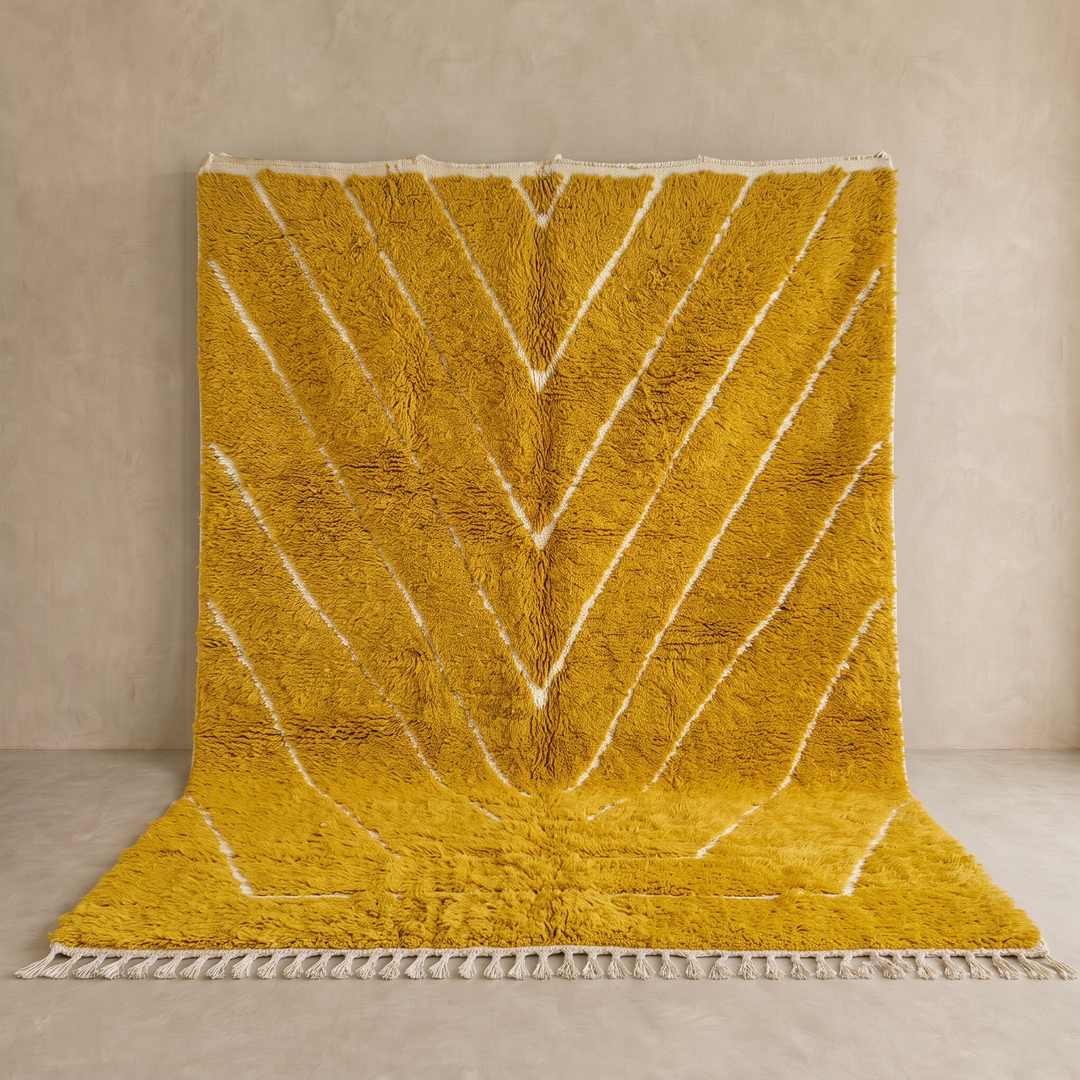 Handmade mustard yellow Moroccan wool rug with ivory geometric lines, plush texture and white tassel fringe.