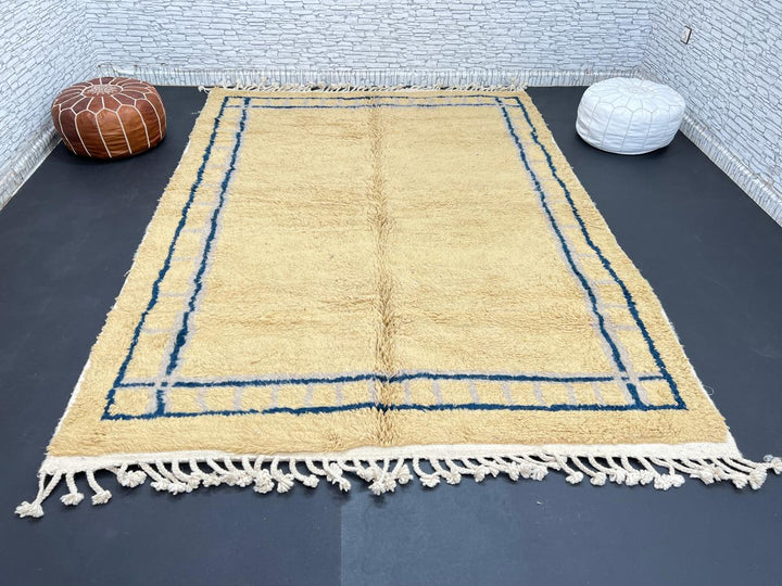 Handmade yellow Moroccan wool rug with blue border, soft plush Beni Mrirt design