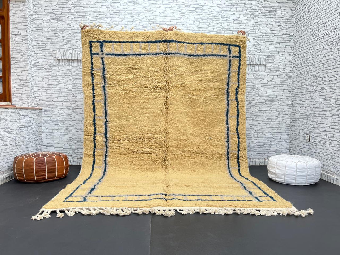 Handmade yellow Moroccan wool rug with blue border, soft plush Beni Mrirt design