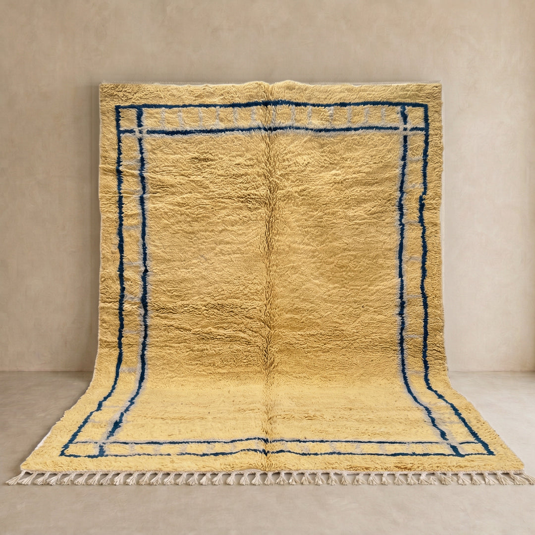 Handmade yellow Moroccan wool rug with blue border, soft plush Beni Mrirt design
