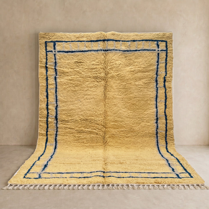 Handmade yellow Moroccan wool rug with blue border, soft plush Beni Mrirt design
