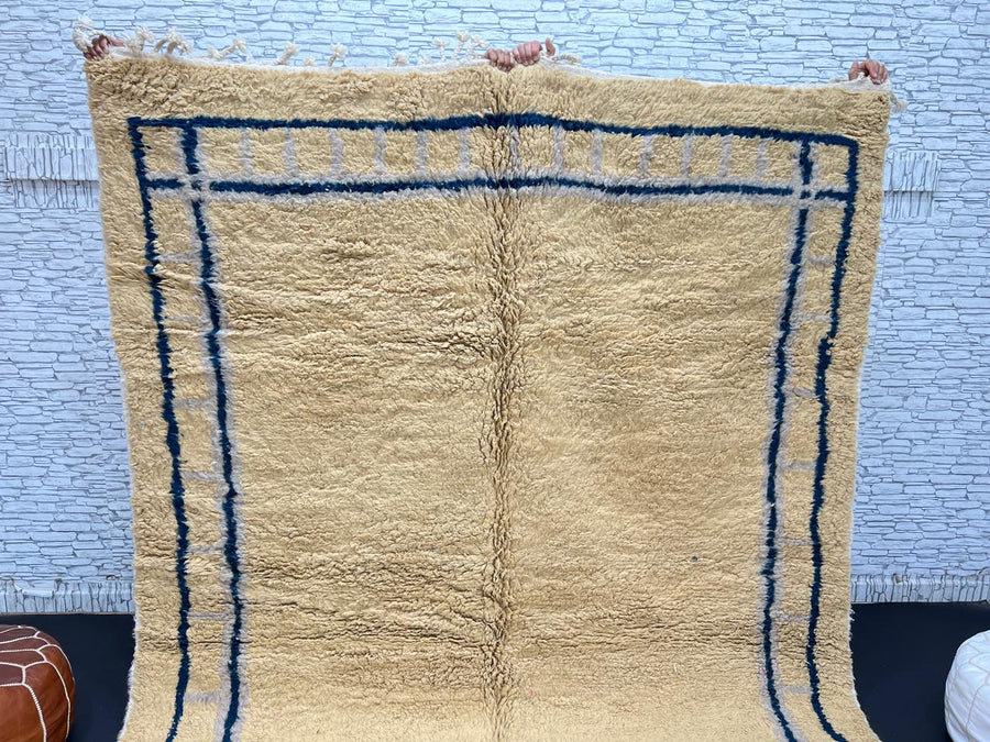 Handmade yellow Moroccan wool rug with blue border, soft plush Beni Mrirt design