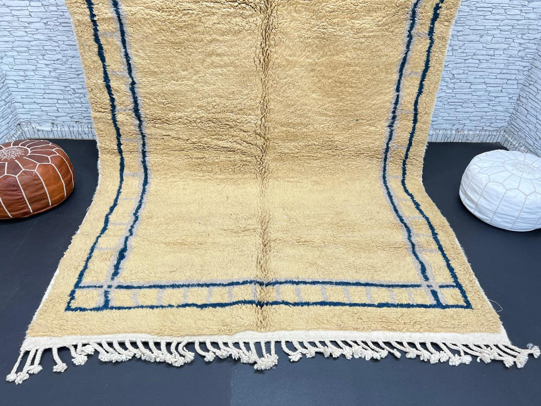 Handmade yellow Moroccan wool rug with blue border, soft plush Beni Mrirt design