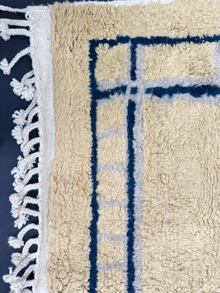 Handmade yellow Moroccan wool rug with blue border, soft plush Beni Mrirt design