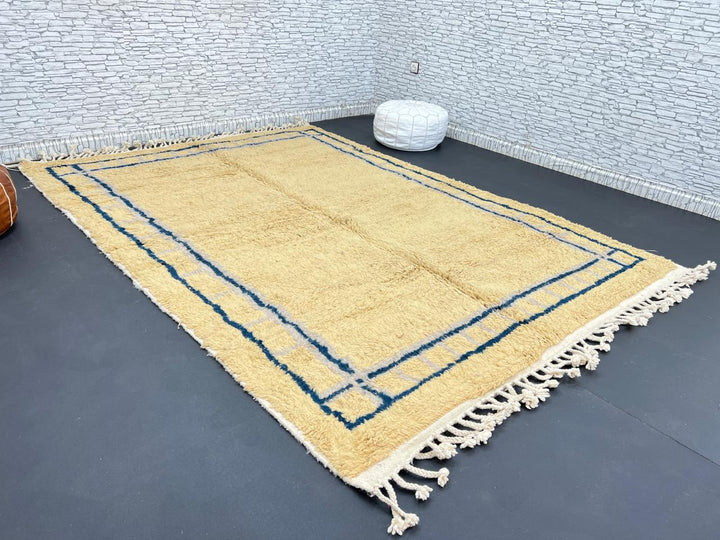 Handmade yellow Moroccan wool rug with blue border, soft plush Beni Mrirt design