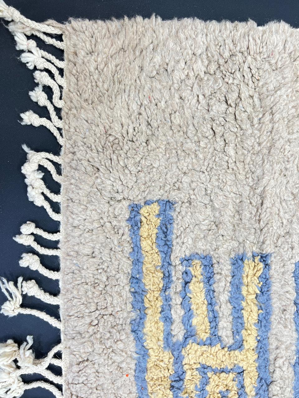 Yellow and blue Moroccan wool rug with geometric Berber border pattern
