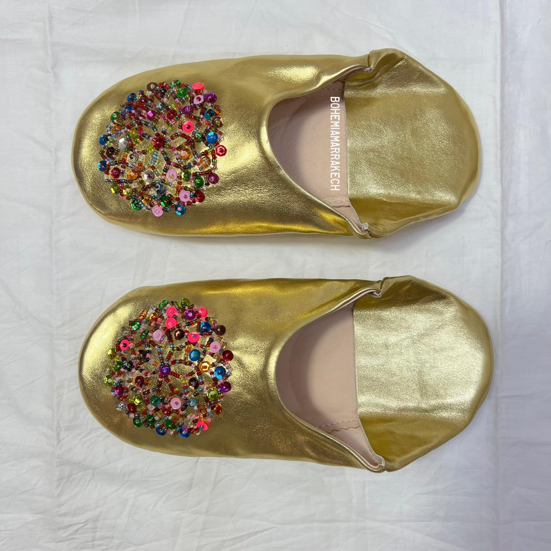 Handmade Moroccan leather babouche slippers with traditional pointed shape and simple hand stitching.