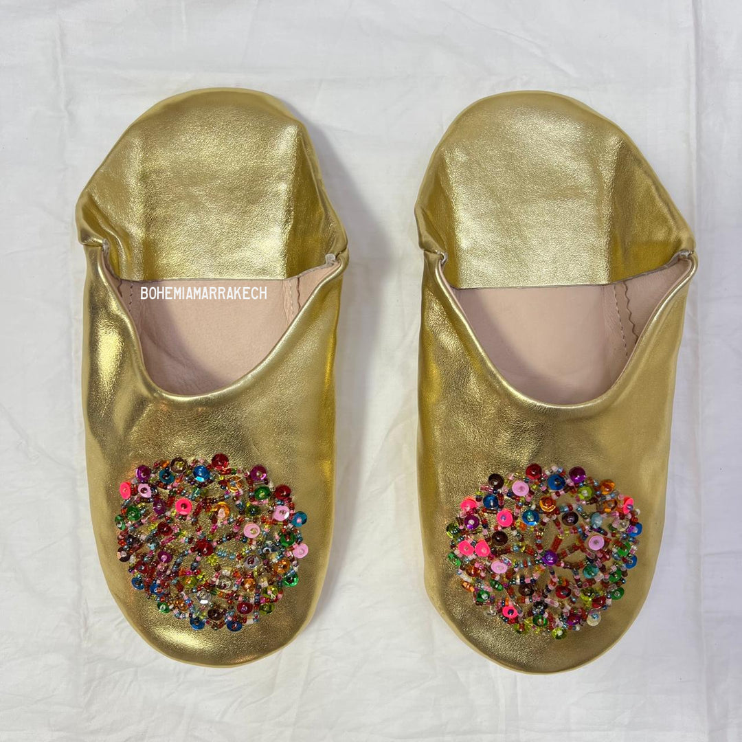 Handmade Moroccan leather babouche slippers with traditional pointed shape and simple hand stitching.