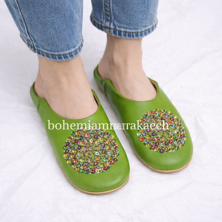 Handmade Moroccan leather babouche slippers with traditional pointed shape and simple hand stitching.