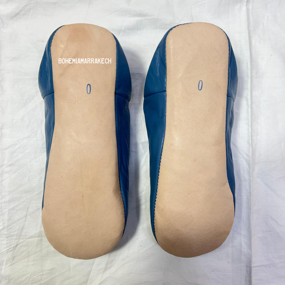 Traditional pointed Moroccan babouche slippers crafted from natural leather.