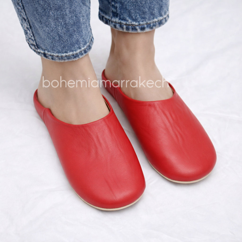 Red handmade Moroccan leather babouche slippers, traditional style.