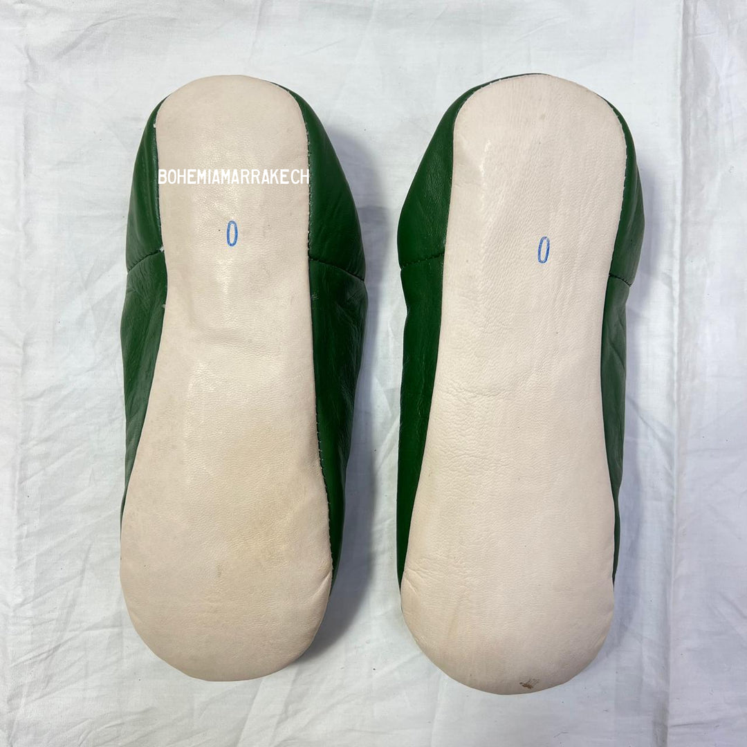 Green handmade Moroccan leather babouche slippers with colorful beaded medallion.