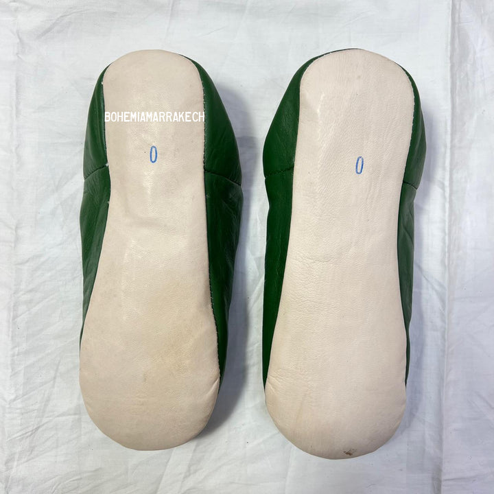 Green handmade Moroccan leather babouche slippers with colorful beaded medallion.