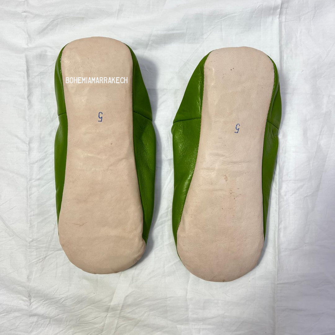 Handmade Moroccan leather babouche slippers with traditional pointed shape and simple hand stitching.