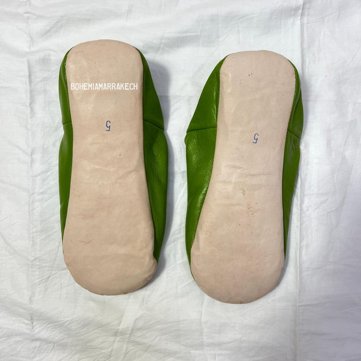 Handmade Moroccan leather babouche slippers with traditional pointed shape and simple hand stitching.