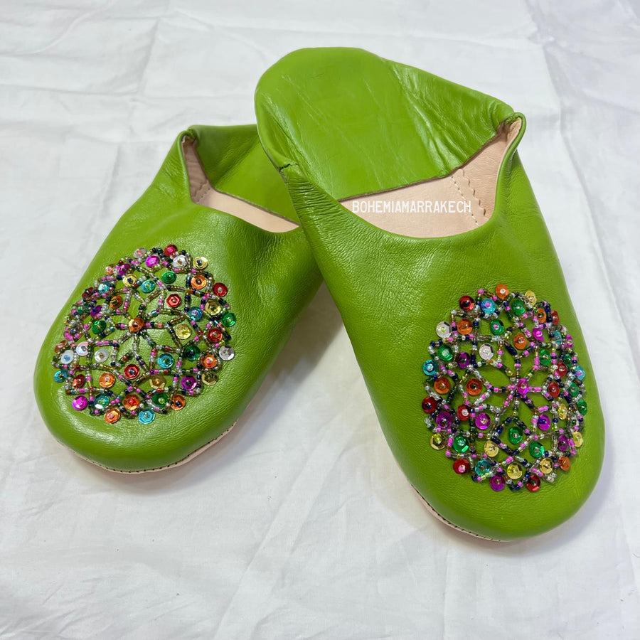 Handmade Moroccan leather babouche slippers with traditional pointed shape and simple hand stitching.