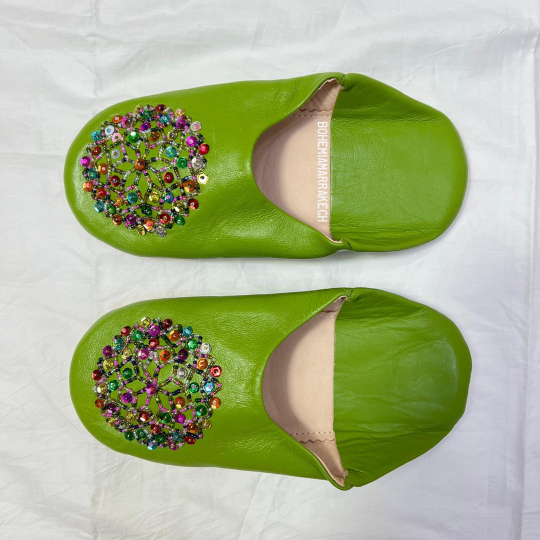 Handmade Moroccan leather babouche slippers with traditional pointed shape and simple hand stitching.