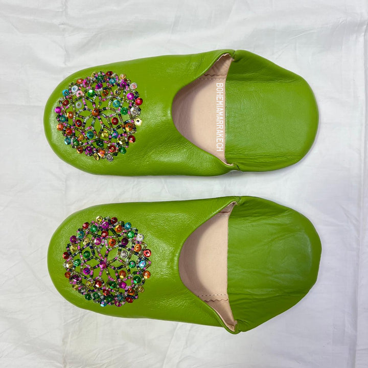 Handmade Moroccan leather babouche slippers with traditional pointed shape and simple hand stitching.