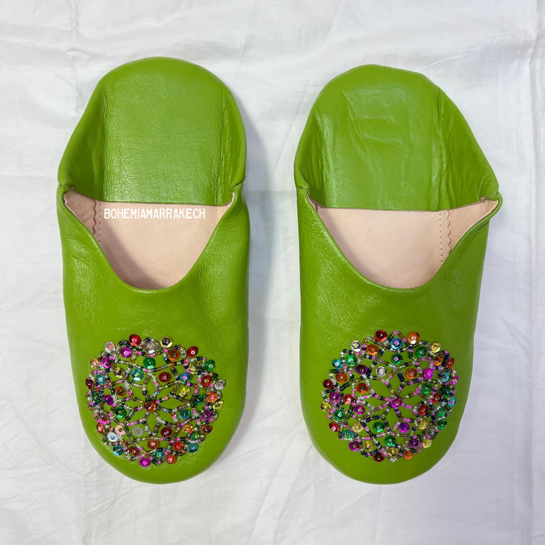 Handmade Moroccan leather babouche slippers with traditional pointed shape and simple hand stitching.
