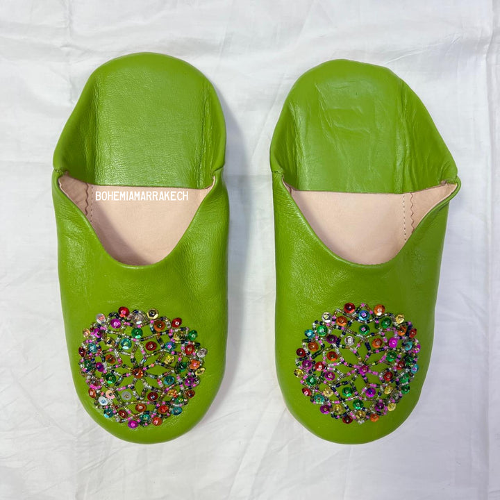Handmade Moroccan leather babouche slippers with traditional pointed shape and simple hand stitching.