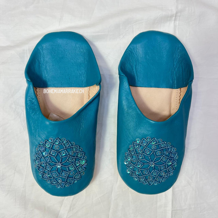 Handmade Moroccan leather babouche slippers with traditional pointed toe and hand stitching.