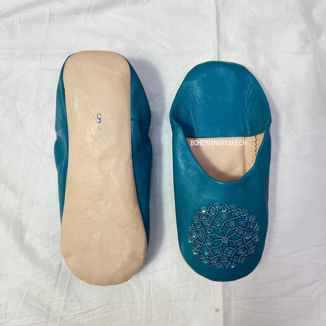 Handmade Moroccan leather babouche slippers with traditional pointed toe and hand stitching.