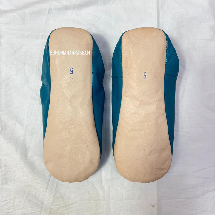 Handmade Moroccan leather babouche slippers with traditional pointed toe and hand stitching.