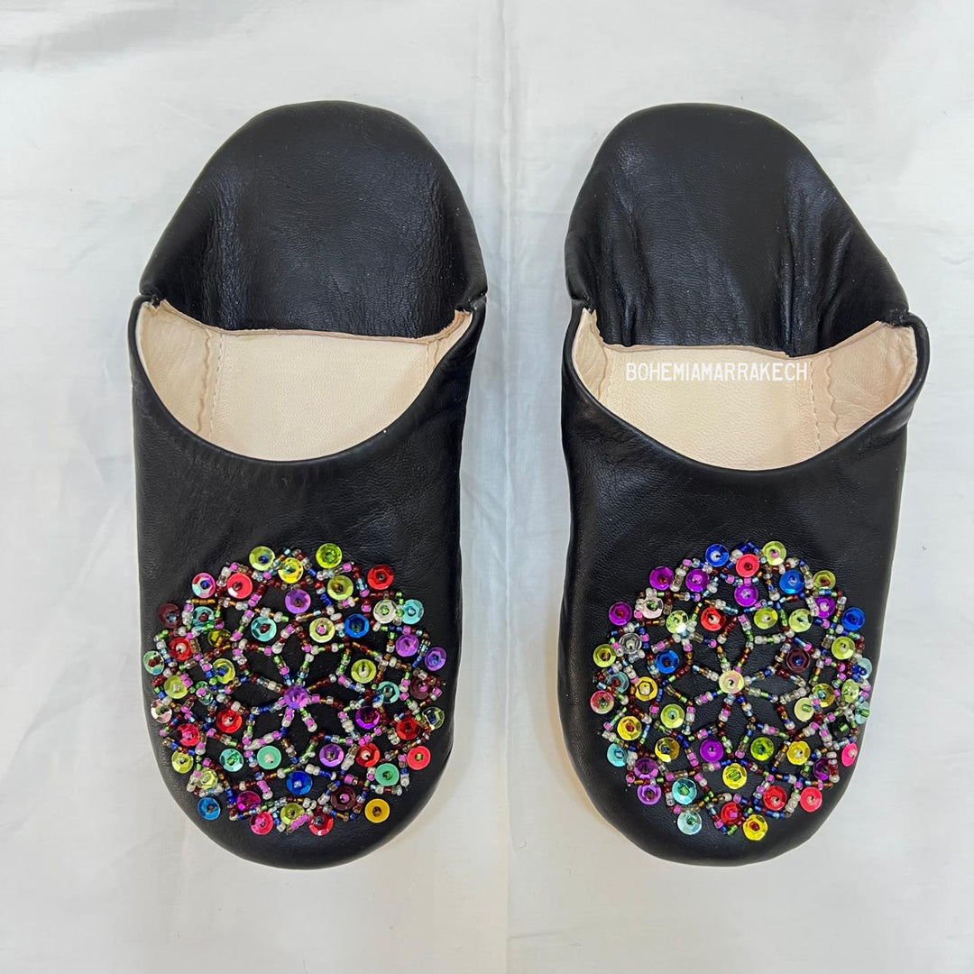 Handmade Moroccan leather babouche slippers with traditional pointed shape and hand-stitched edges.