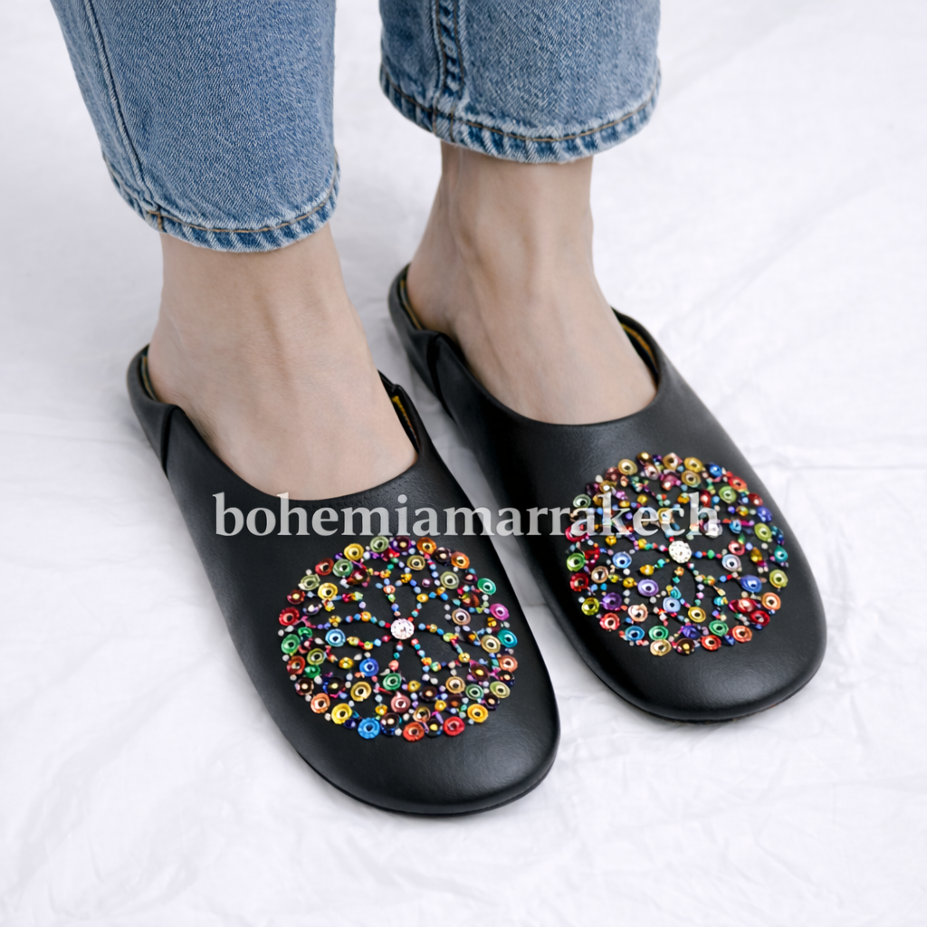 Handmade Moroccan leather babouche slippers with traditional pointed shape and hand-stitched edges.