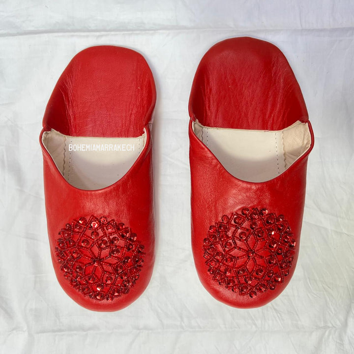 Artisan-made Moroccan babouche slippers with simple stitched details.