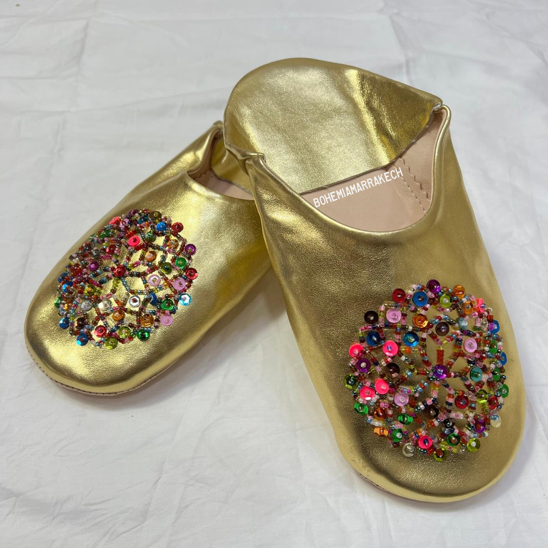 Handmade Moroccan leather babouche slippers with traditional pointed shape and simple hand stitching.