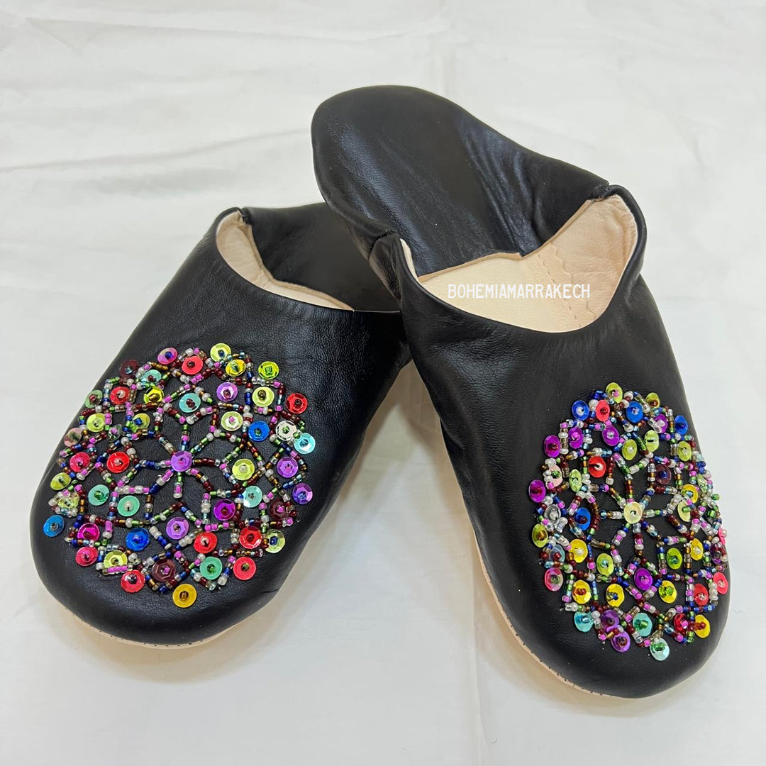 Handmade Moroccan leather babouche slippers with traditional pointed shape and hand-stitched edges.