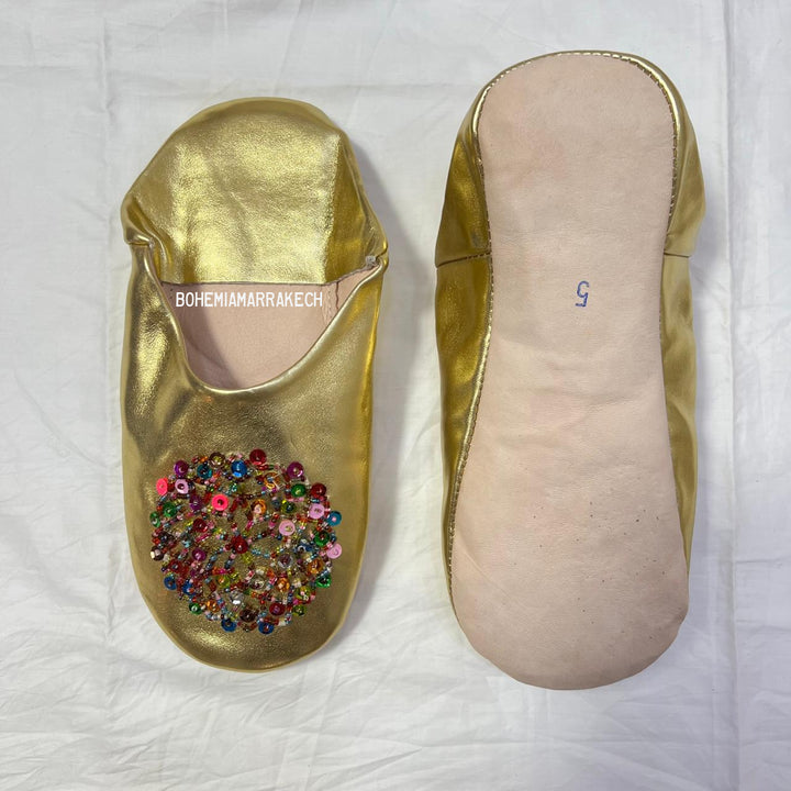 Handmade Moroccan leather babouche slippers with traditional pointed shape and simple hand stitching.