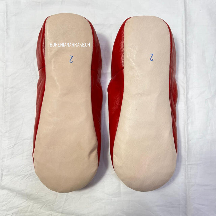 Artisan-made Moroccan babouche slippers with simple stitched details.