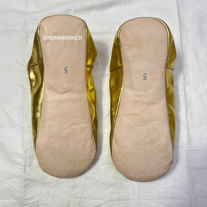 Handmade Moroccan leather babouche slippers with traditional pointed shape and simple hand stitching.