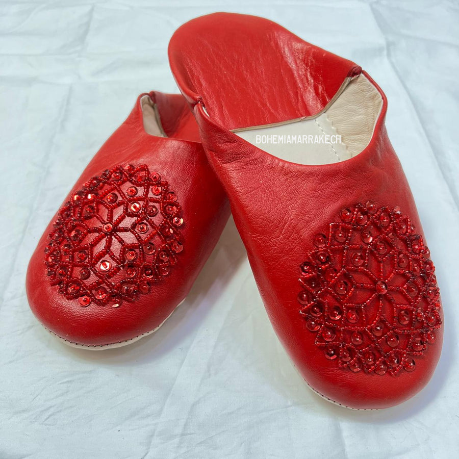 Artisan-made Moroccan babouche slippers with simple stitched details.