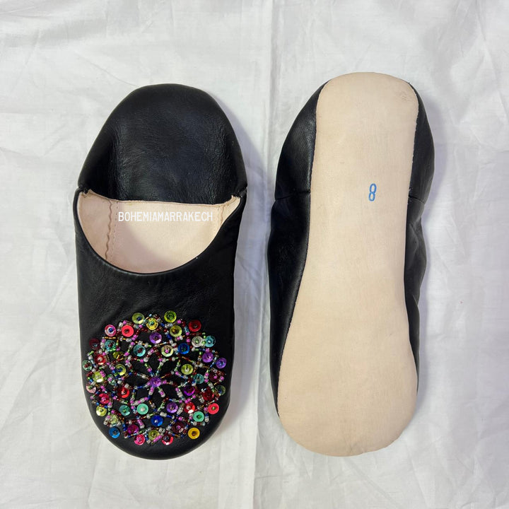 Handmade Moroccan leather babouche slippers with traditional pointed shape and hand-stitched edges.